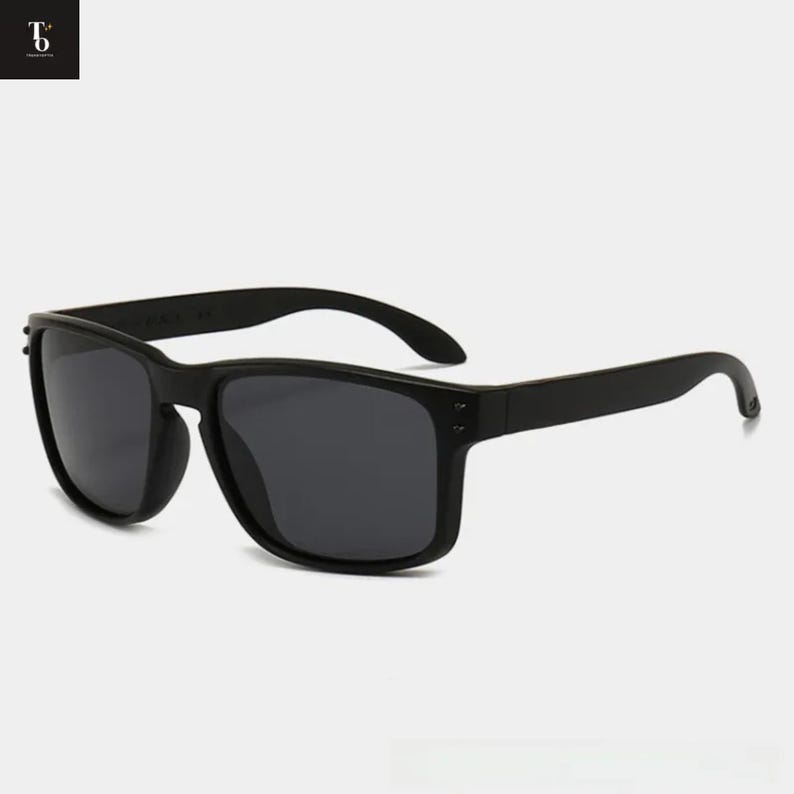 May include: Black sunglasses with a rectangular frame and dark lenses. The sunglasses have a matte finish and a classic, timeless design. The arms curve slightly for a comfortable fit. A stylish accessory for sun protection.