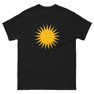 May include: Black t-shirt featuring a large, yellow sunburst design centered on the chest. The sunburst has pointed rays radiating outwards. The shirt is made of a soft material.