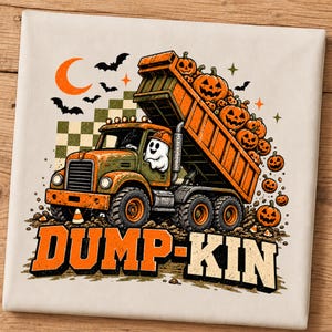 May include: A cream-colored t-shirt featuring a graphic of an orange dump truck driven by a ghost wearing a hard hat. The truck bed is filled with jack-o'-lanterns, with more pumpkins on the ground. The text DUMP-KIN is printed in orange below.