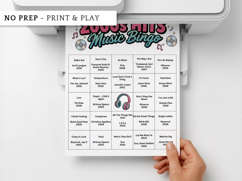 May include: A printed 2000s Hits Music Bingo game sheet with song titles and artists. The sheet is white with a colorful header and is being printed from a printer. The words "NO PREP - PRINT & PLAY" are at the top.