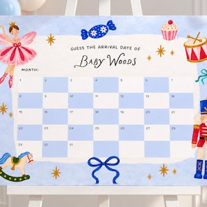May include: A rectangular sign with a light blue border featuring the text GUESS THE ARRIVAL DATE OF BABY WOODS. The design includes a calendar grid, a ballerina, a nutcracker, a rocking horse, a cupcake, a drum, and blue bows.