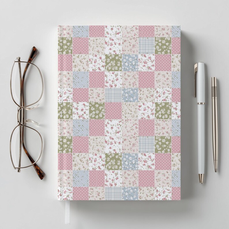 May include: A notebook with a patchwork design featuring squares of floral, polka dot, and plaid patterns in pink, green, and blue. A pair of eyeglasses and two pens are next to the notebook.