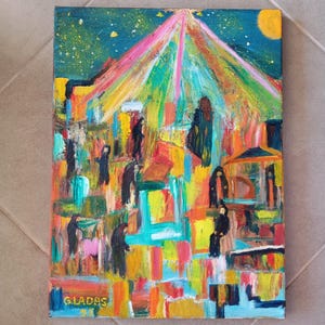 May include: An abstract painting with a vibrant colour palette. The artwork features a night scene with figures, buildings, and a radiant light source. The artist's signature, GLADAS, is visible in the lower left corner. The painting is on a canvas.