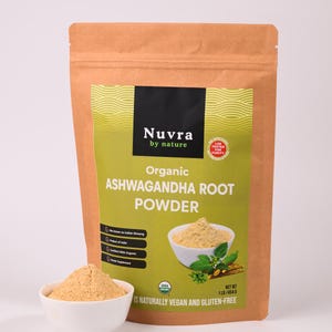 May include: A brown paper bag of Nuvra Organic Ashwagandha Root Powder with a white bowl of powder in front. The bag has a green label with text and an image of powder in a bowl. The bag is labeled as USDA Organic and gluten-free. The net weight is 1 lb / 454 g.