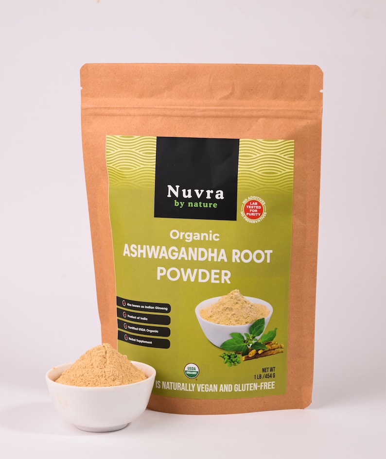 May include: A brown paper bag of Nuvra Organic Ashwagandha Root Powder with a white bowl of powder in front. The bag has a green label with text and an image of powder in a bowl. The bag is labeled as USDA Organic and gluten-free. The net weight is 1 lb / 454 g.