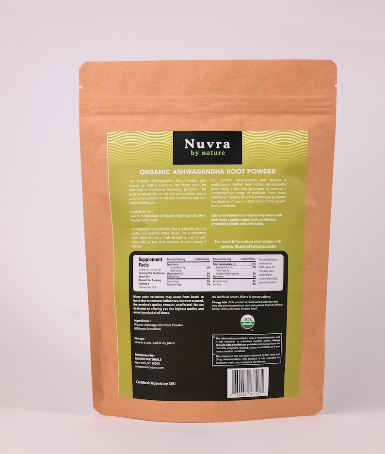 May include: A brown paper bag of Nuvra Organic Ashwagandha Root Powder. The bag has a green and white label with the brand name and product information. The label includes the text "Supplement Facts" and "Certified Organic by QAI".