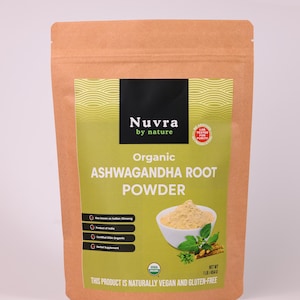 May include: A brown paper bag of organic ashwagandha root powder. The label features the brand name "Nuvra by nature" and the text "Organic Ashwagandha Root Powder." The bag also states the product is vegan and gluten-free, with a net weight of 1lb/454g.