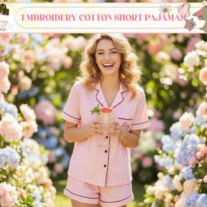 May include: Pink cotton short pajamas with black trim. The set includes a short-sleeved button-up shirt and matching shorts. The text "Embroidery Cotton Short Pajamas" is displayed at the top of the image.
