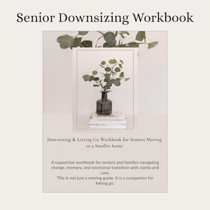 May include: A workbook titled "Senior Downsizing Workbook" with text that reads "Downsizing & Letting Go Workbook for Seniors Moving to a Smaller home." The image includes a framed picture with a vase of greenery on top of a stack of books.