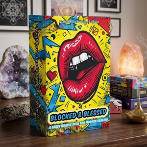 May include: A rectangular oracle deck box titled Blocked & Blessed, A Sassy Oracle Deck for Modern Healing. The box features a vibrant yellow background with a large red pair of lips, blue lightning bolts, and red hearts in a comic book style.
