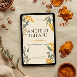 May include: A tablet displaying a digital cover titled ANCIENT UBTANS 7 Ayurvedic Soap-Free Cleansers THE AYURVEDIC ALCHEMIST, decorated with yellow and green leaf illustrations, surrounded by small bowls of turmeric powder and scattered dried herbs.