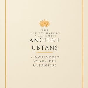 May include: A cream-colored rectangular product label featuring a gold lotus icon at the top. The text reads: THE THE AYURVEDIC ALCHEMIST ANCIENT UBTANS 7 AYURVEDIC SOAP-FREE CLEANSERS. The design is enclosed within a thin gold double-line border.