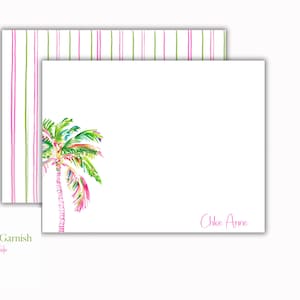 May include: White stationery set featuring a watercolor palm tree design in shades of green, pink, and yellow. The set includes a notepad with a matching striped pattern on the back and the name "Chloe Anne" in pink.