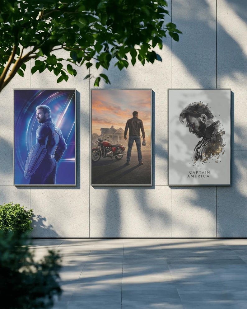 May include: Three framed art prints displayed outdoors. The prints feature images of a superhero in a blue and purple setting, a man with a motorcycle, and a portrait with the text "CAPTAIN AMERICA".