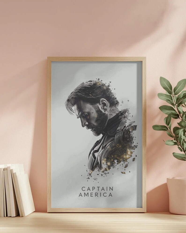 May include: Framed art print featuring a grayscale portrait of Captain America. The artwork shows a side profile of the character with a beard, set against a light gray background. The words "CAPTAIN AMERICA" are printed at the bottom.