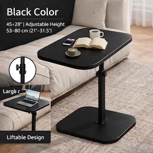 May include: Black adjustable side table. The table is 114 x 71 cm and has an adjustable height of 53-80 cm. The table has a square base and a rectangular tabletop. The image shows a cup, a book, and a phone on the table. The text says 'Black Color'.