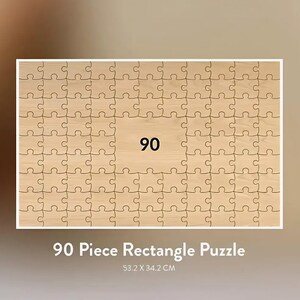 May include: A rectangular wooden puzzle with 90 pieces. The center of the puzzle features the number "90". The puzzle measures 53.2 x 34.2 cm (20.9 x 13.5 inches) and has the text "90 Piece Rectangle Puzzle" at the bottom.