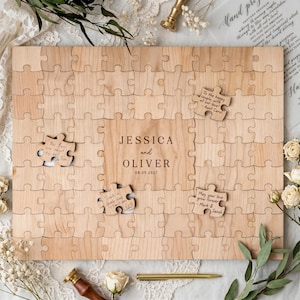 May include: A wooden puzzle guest book with the names "JESSICA and OLIVER" and the date "08.09.2027" engraved on it. Several puzzle pieces are missing, with handwritten notes on some. The puzzle is surrounded by floral decorations.