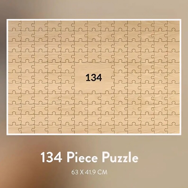 May include: A wooden 134-piece puzzle with a light brown finish. The number "134" is printed in black in the center of the puzzle. The puzzle measures 24.8 x 16.5 inches. The text "134 Piece Puzzle" is displayed below the puzzle.