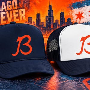 May include: Two trucker caps featuring a bold orange letter B on the front. One cap is solid navy blue, while the other has a white front panel and navy blue mesh back. Both caps have a curved brim and a structured crown design for a classic look.