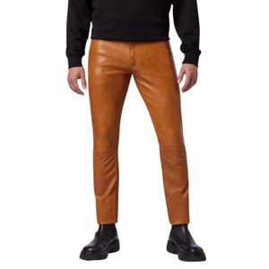 May include: Tan leather trousers with a classic five-pocket design. The trousers have a straight leg cut and are paired with black boots. The leather has a smooth, matte finish. The trousers are a medium brown colour.