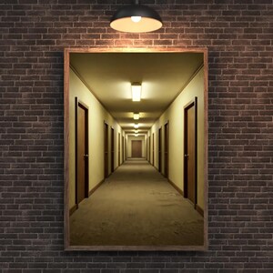 May include: A framed print depicting a long corridor with doors lining both sides, stretching into the distance. Overhead lights illuminate the space. The frame is brown, set against a brick wall.