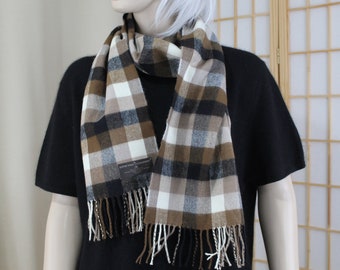 May include: A brown, black, and white plaid scarf with fringe. The scarf is made of a soft, warm material and is perfect for keeping you warm in the winter.