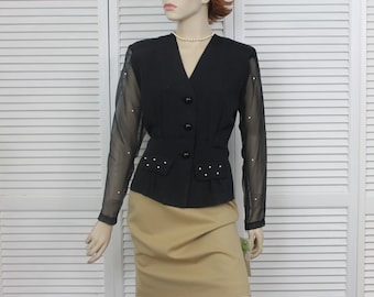May include: A black blazer with sheer sleeves featuring pearl embellishments. The blazer has a v-neckline and a button closure.