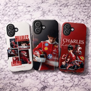 May include: Three phone cases with racing designs. One is white with red accents and the name "CHARLES" and "LECLERC" printed on it. The other two are black and red, featuring images of a race car driver.