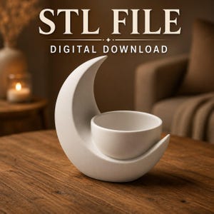May include: A white ceramic-style object shaped like a crescent moon with an integrated circular bowl. The text STL FILE DIGITAL DOWNLOAD is displayed in white at the top of the image. The object has a smooth, matte finish and a curved base.