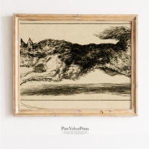 May include: A framed vintage print featuring a running dog illustration in black and white. The artwork is set against a cream-colored background and is enclosed in a light brown wooden frame. The print has the text "PawVelvetPrints" at the bottom.