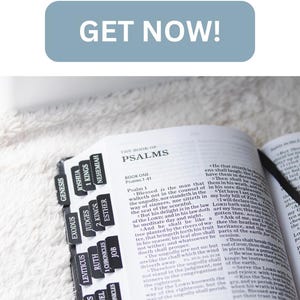 May include: A black tabbed Bible with an engraved design on the cover. The book has black tabs and the name "Joseph" is printed on the cover. The open pages show text from the Psalms.