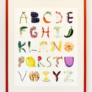 May include: A framed alphabet art print featuring letters A through Z formed by various fruits, vegetables, and nuts. Each letter is illustrated in watercolor style with vibrant colors, set against a white background within a thin red frame.