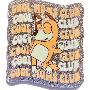May include: A glittery square pin featuring a cartoon dog in an orange and white outfit. The pin has the words "COOL MOMS CLUB" in orange and white. The background is silver glitter.