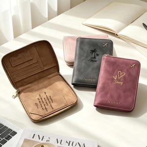 May include: Three zippered passport holders in tan, dark gray, and maroon. The tan holder is open, revealing card slots and text that reads: Explore the wonderful world and carry my sincere thoughts all the way xx Alice. The others feature airplane icons.