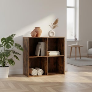 May include: A four-cube wooden bookshelf with a distressed brown finish. The shelves hold books, rolled towels, and decorative vases. A potted plant is to the left, and a window is in the background.