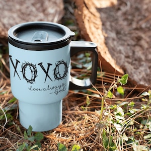 May include: A light blue travel mug with a black lid and handle. The mug has a black design that says "XOXO love always - God" on it.