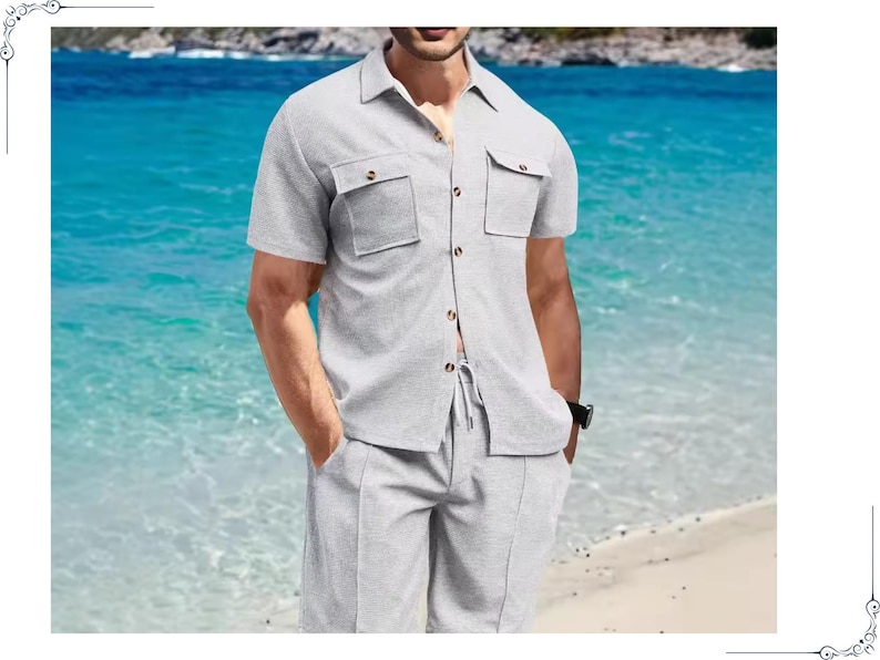 May include: A light gray short-sleeved shirt and shorts set. The shirt has two chest pockets and button closures. The shorts have a drawstring waist. The outfit is made of a textured fabric, perfect for a casual summer look.