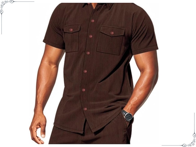 May include: Brown short-sleeved shirt with two chest pockets and matching pants. The shirt has a button-down front and a classic collar. The fabric has a vertical ribbed texture. The outfit is a solid brown color.