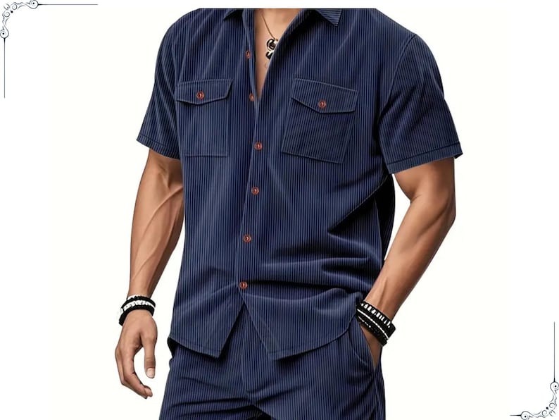 May include: Navy blue short-sleeve shirt and matching pants. The shirt has two chest pockets and brown buttons. The fabric has a vertical ribbed texture. The outfit is a coordinated set.