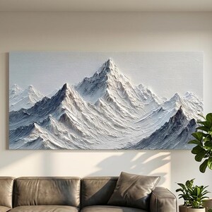 May include: A large rectangular canvas artwork showing a mountain range with snow-covered peaks. The painting has a textured, three-dimensional effect with white, grey, and blue tones. The artwork hangs above a dark grey sectional sofa.