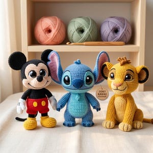 May include: Three handmade crochet amigurumi dolls featuring a black and white mouse, a blue alien with large ears, and a yellow lion cub. The blue doll has a round wooden tag attached that reads Disney Kawaii Handmade in black text.