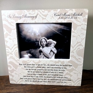 May include: A white picture frame with a lace design and a black and white photo of a woman and a young girl hugging. The frame has the text "In Loving Memory of Carol Marie Mitchell 1.10.59-6.20.08" and a poem about remembering a loved one.