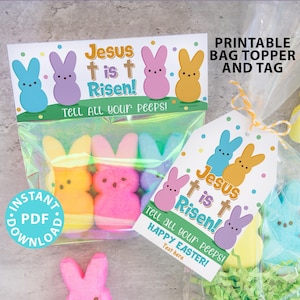 May include: Printable Easter bag topper and tag featuring a colorful design with the text "Jesus is Risen!" and a group of pastel-colored Peeps. The tag also includes the text "Tell all your peeps! Happy Easter!"