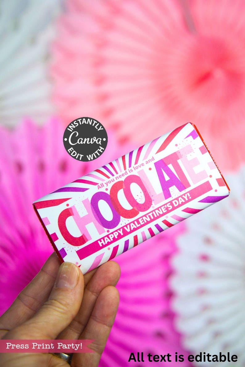 May include: A Valentine's Day-themed chocolate bar wrapper with the word "CHOCOLATE" in pink and purple. The wrapper also includes the text "All you need is love and HAPPY VALENTINE'S DAY!" on a white background with pink and purple stripes.