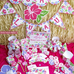 May include: A luau themed party set with pink, purple, and green floral designs. The set includes a banner, cupcake wrappers, cupcake toppers, favor boxes, water bottle wrappers, a sign, and a large hibiscus flower cutout. The text on the sign reads "Aloha! Maddy's party is here Come on in".