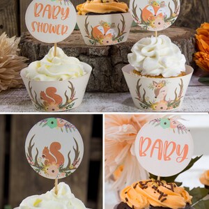 May include: A set of cupcake wrappers with a woodland theme. The wrappers feature a fox, a deer, and a squirrel. The wrappers are decorated with flowers and antlers. The text "Baby Shower" is on one of the cupcake toppers.