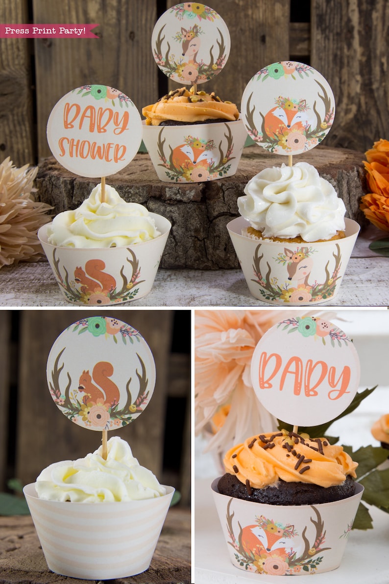 May include: A set of cupcake wrappers with a woodland theme. The wrappers feature a fox, a deer, and a squirrel. The wrappers are decorated with flowers and antlers. The text "Baby Shower" is on one of the cupcake toppers.