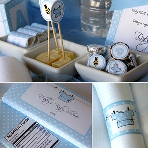 K&ouml;nnte beinhalten: Eine blaue und wei&szlig;e Geschenkbox mit wei&szlig;en Punkten und einem wei&szlig;en Etikett mit der Aufschrift "Debby's Baby Shower" und einem blauen und wei&szlig;en Baby-Strampler-Motiv. Die Box ist mit einem blauen Band und einer wei&szlig;en Schleife verziert.