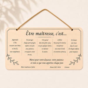 May include: A rectangular wooden sign with a light brown background and a decorative border. The sign has text in French, including the words "&Ecirc;tre ma&icirc;tresse, c'est..." and a message of appreciation for a teacher. A jute rope is attached for hanging.